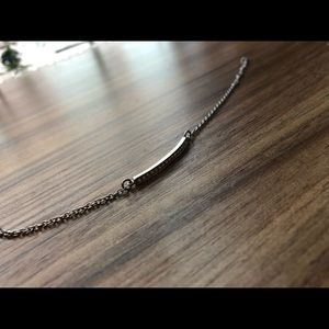 Adjustable silver bracelet with rhinestones.